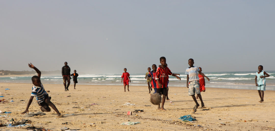 Other children playing football on the beach!